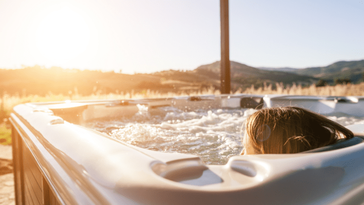 Woman sitting in hot tub outdoors.