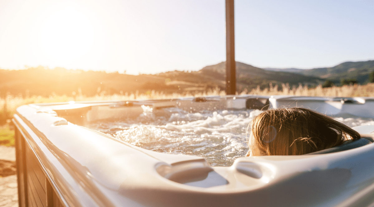 Woman sitting in hot tub outdoors.